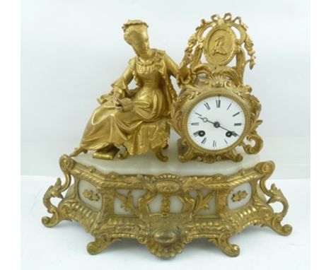 A FRENCH ROCOCO DESIGN GILDED SPELTER MANTEL CLOCK, circa 1900, mounted with a woman of fashion examining the contents of a j