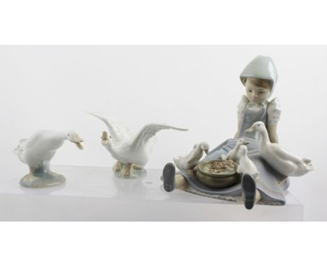 A LLADRO FIGURINE "My Hungry Brood", a girl seated with ducks, 17cm high, together with TWO GEESE FIGURINES (3) 