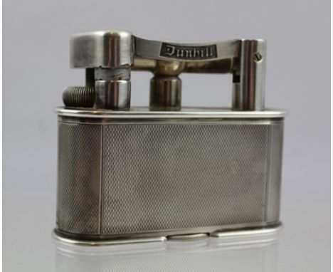 A "DUNHILL" ELECTRO-PLATED MID 20TH CENTURY TABLE LIGHTER, having engine turned body, hinged arm, patent no. 390107, design n
