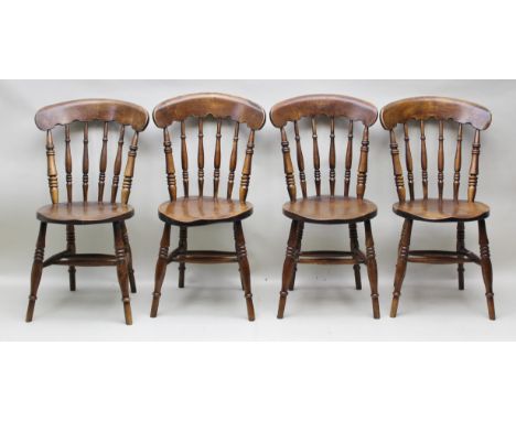 A SET OF FOUR ELM BARREL SEATED STICK BACK KITCHEN CHAIRS on ring turned supports with stretchers 