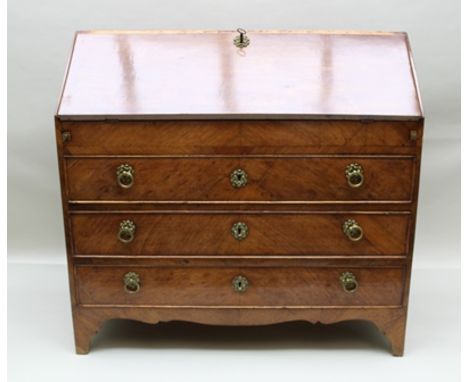 A GEORGE III MAHOGANY FALLFRONT BUREAU fitted three long drawers to base with brass ring drop handles, on bracket feet, 107cm