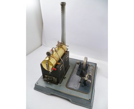 A "MARKLIN" TIN-PLATE STEAM ENGINE with brass boiler, set into an embossed brick factory effect stand, with working wheel, on