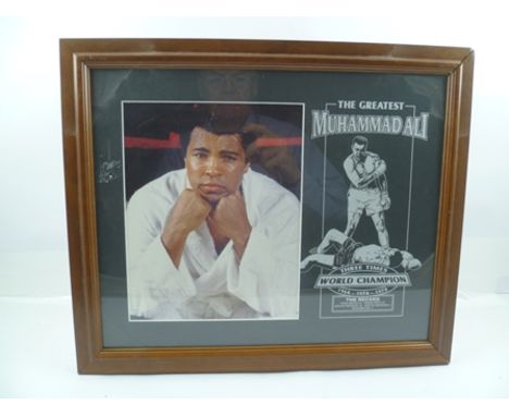 A FRAMED PHOTOGRAPH OF MUHAMMAD ALI the mount printed with his boxing ring results and "Three Times World Champion in 1964, 1