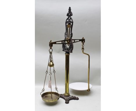 A SET OF VICTORIAN COUNTER TOP SCALES, decorative cast iron and brass construction, with brass pan and ceramic platen, 89cm h