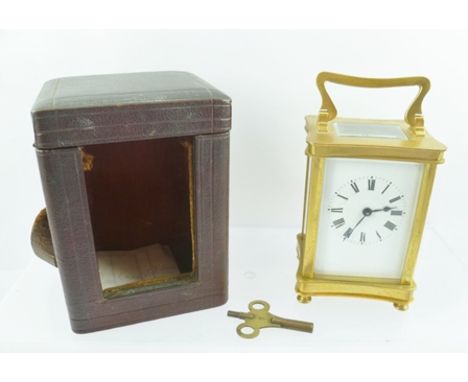 A LATE 19TH CENTURY BRASS CARRIAGE CLOCK, having white enamel dial with Roman numerals, in original outer leather covered cas