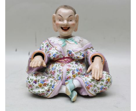 A 19TH CENTURY CONTINENTAL CERAMIC NODDING BUDDHA with moving hands and protruding tongue, floral enamel decoration 