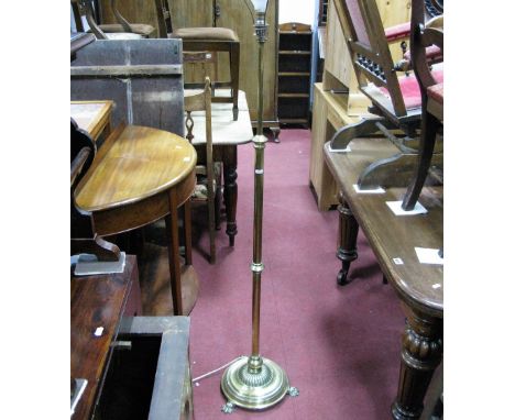 A Victorian Brass Oil Lamp, converted to electric, rise and fall stem, on three spreading claw feet.