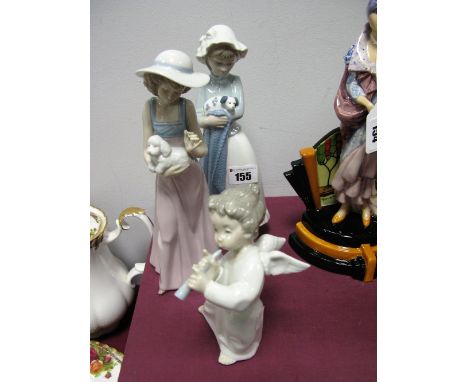 A Lladro Model of an Angel Playing a Horn, 16cm, and two Nao figures of young girls holding puppies. (3)