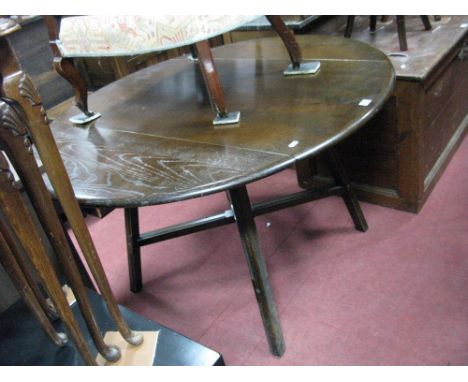 An Ercol Dark Elm Drop Leaf Dining Table. 