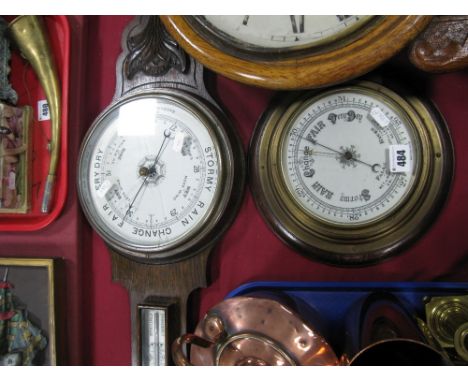 An Early XX Century Oak and Brass Circular Aneroid Barometer; together with one other aneroid barometer, glass (damages).