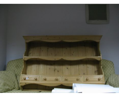 A Wall Hanging Pine Rack, with a shaped cornice, single shelf and three small drawers. 