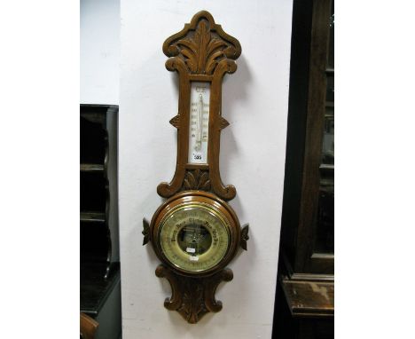 An Early XX Century Oak Aneroid Barometer, with top and bottom, temperature gauge, dial with brass bezel.