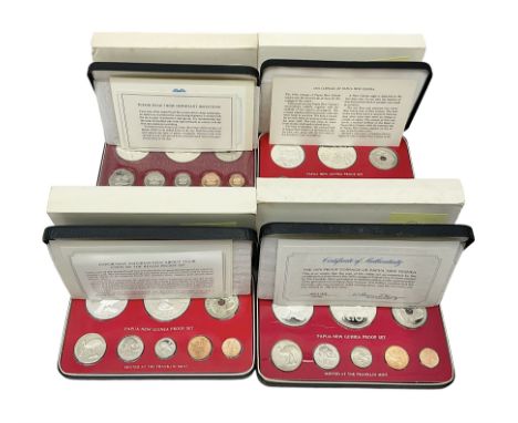 Four Papua New Guinea proof eight coin sets, from ten kina to one toea, comprising First Coinage of Papua New Guinea 1975 pro