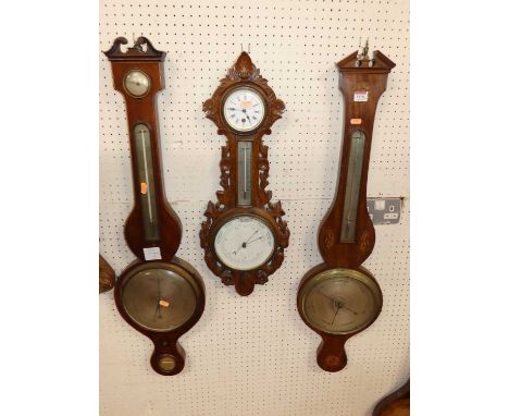 Two 19th century mahogany and inlaid wheel barometers; together with an incomplete wheel barometer; and an early 20th century