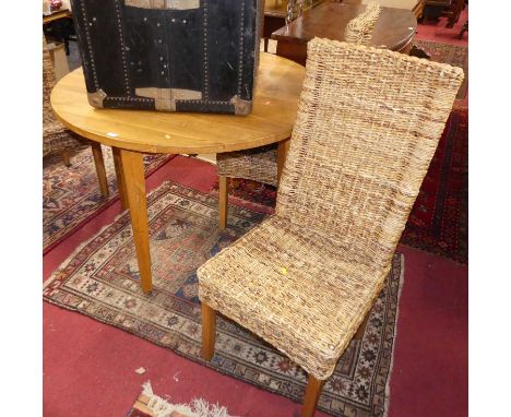 A contemporary light oak circular breakfast table, dia.110cm; together with a set of four wicker chairs (5)