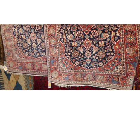A pair of Persian red and blue ground Isfahan woollen rugs, each 160 x 106cmOverall in very good condition with some light lo