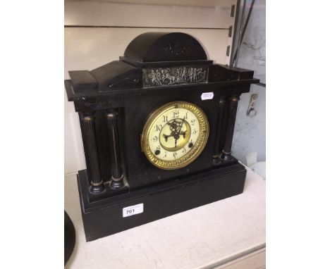 A 19th century black slate mantle clock with visible escapement, with pendulum and key. 
