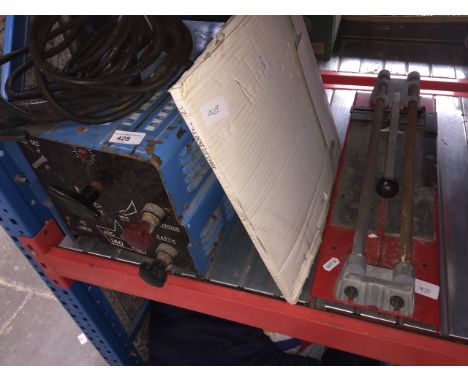 A Weldspares 140 welder and a manual tile cutter and some saw blades. 