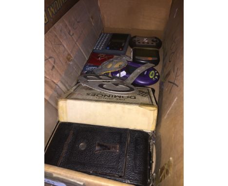 A box of collectables to include AA car badge, GB sign, dominoes, old folding camera, penknives, games, etc. 