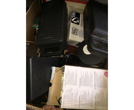 A box of music cassettes, a camera, cine films, cases, etc. 
