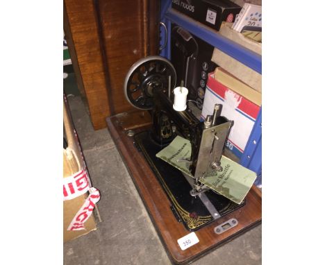 A vintage Vesta boat shuttle sewing machine in original wooden case, with key and manual. 