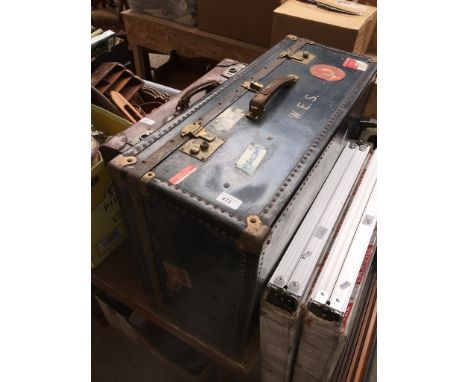 A large travel trunk with various stickers. 
