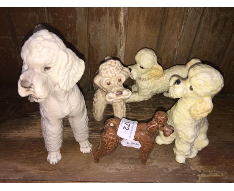 Four ceramic poodles 