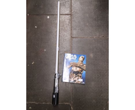 A Star Wars Lucasfilm master replica light sabre and "The Magic Myth" book 