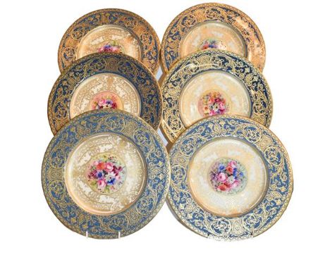 Royal Worcester cabinet plates with blue borders, profuse gilt decoration and central floral panels signed E Phillips, with t