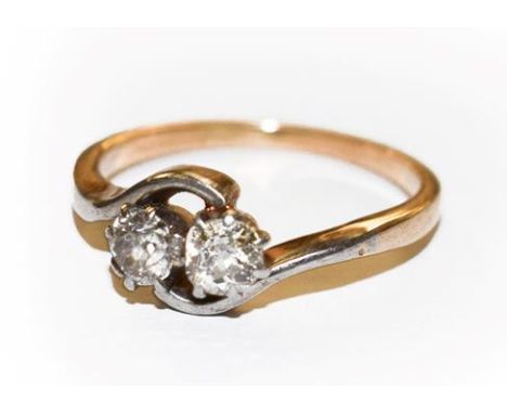 A diamond two stone twist ring, finger size M.  Unmarked. Gross weight 2.8 grams. 