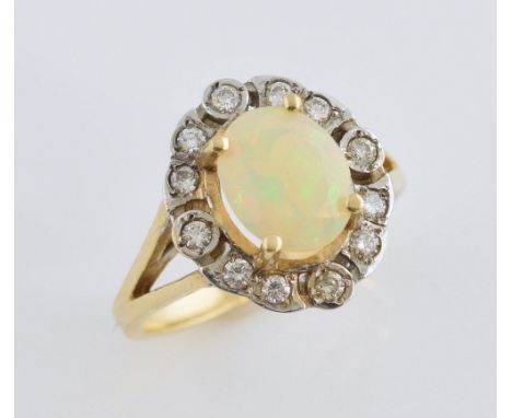 Opal and diamond cluster ring, centrally set oval faceted opal, estimated weight 1.65 carats, within a border of round brilli