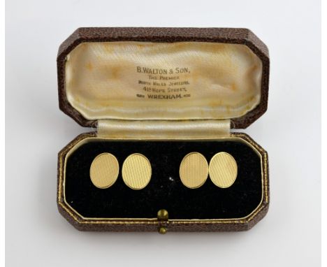 A pair of 1950's gold cufflinks, oval engine turned panels, with chain link attachment, in 9ct yellow gold, hallmarked Birmin