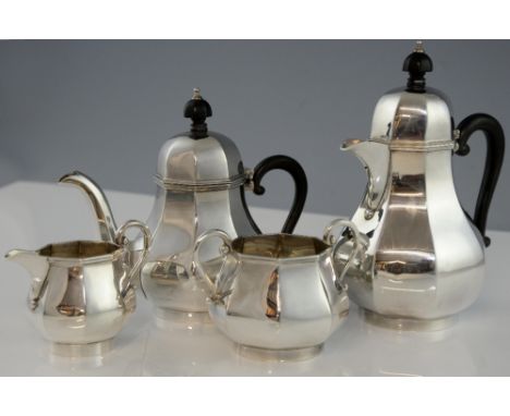 George V silver four piece tea service, comprising tea pot, hot water jug, cream jug and sugar bowl, the bodies of octagonal 