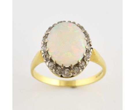 Vintage opal and diamond ring, central oval cabochon cut opal, estimated weight 1.93 carats, surrounded by a border of Swiss 