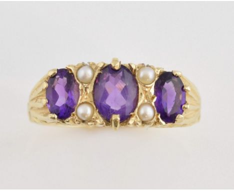 Amethyst and pearl dress ring, three oval cut amethysts set with four seed pearls, mounted in 9 ct yellow gold, size Q.     G