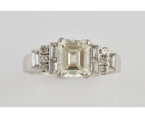 Emerald cut diamond ring,in a raised setting with baguette and brilliant cut diamonds, central stone of 1.44 carats, in a whi