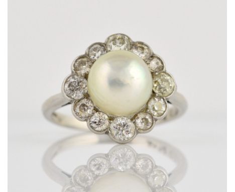 Diamond and pearl ring, with central half pearl and a border of old cut diamonds set in platinum, total diamond weight estima