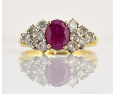 Ruby and diamond dress ring, central oval cut ruby, set with twelve round brilliant cut diamonds, mounted in yellow and white