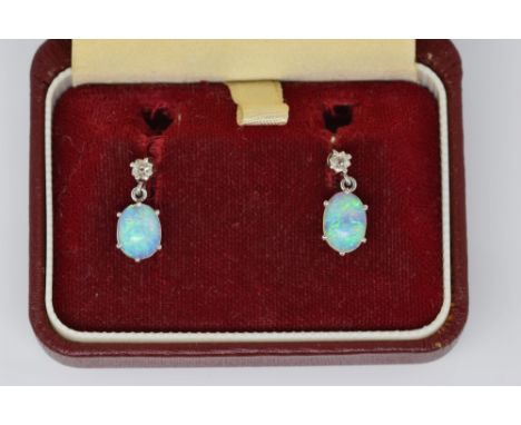 Opal and diamond drop earrings, two articulated oval cabochon cut opals, each measuring approximately 7.8 x 5.6 mm, with old 