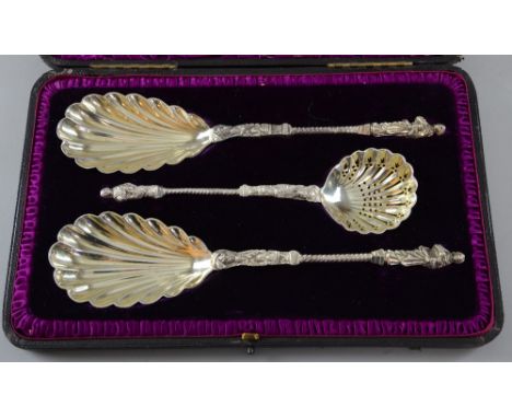 Set of three Victorian silver spoons, one a sifter spoon, with figural terminals and shell moulded bowls, by William Hutton &