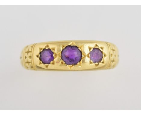 Vintage amethyst set gold ring, three stones and engraved shoulders set in 18 ct gold, ring size R   .     6.4 grams gross, o