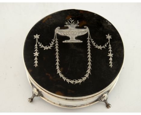 George V silver and tortoiseshell circular trinket box with inlaid decoration on four claw feet, by Charles Boyton & Son Ltd.