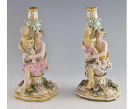 A pair of Meissen style figural candlesticks, early 20th century, each modelled as a seated figure in classical robes holding