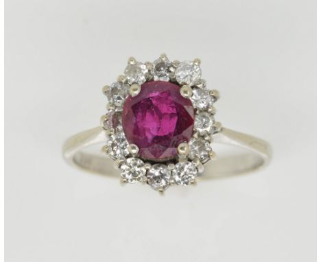 Ruby and diamond cluster ring, oval cut ruby estimated weight 0.92 carat, surrounded by round brilliant cut diamonds, mounted