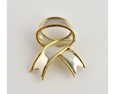 Tiffany & Co ribbon brooch, in white metal stamped silver with raised edge stamped 18 ct, measuring approximately 3.2 x 3 cm,