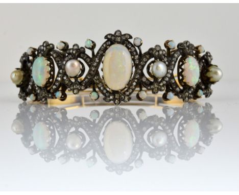 Continental  opal and diamond set bangle, with three large cabochon opals, pearls and rose cut diamonds, silver front and gol