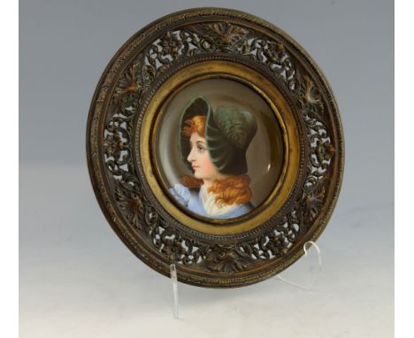 Continental plate with portrait of a young lady, within a cast and pierced metal frame, 31cm.    