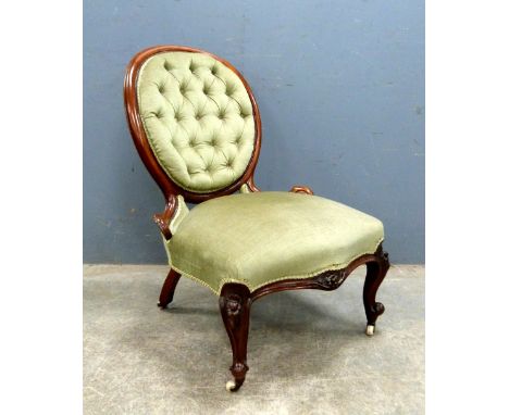 Victorian mahogany and upholstered button back  upholstered chair on carved scrolled legs to castors, 86 cm's.    