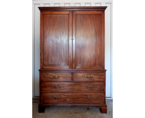 George III mahogany linen press with cupboard doors over two short and two long drawers, on bracket feet, fitted interior. 19