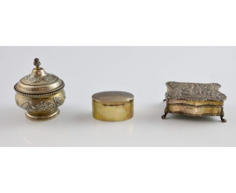 Three silver boxes with marks for Chester, comprising a fitted silver jewellery box, the cover embossed with Regency figures,